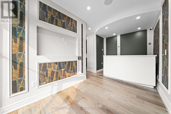 Interior lobby area with a white reception desk and patterned wall accents. - 431 Dougall Avenue, Caledon