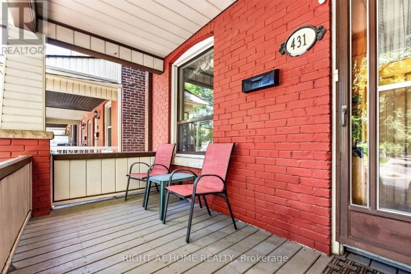 Close-up of the front porch with two chairs and a table. - 431 Lansdowne Avenue, Toronto