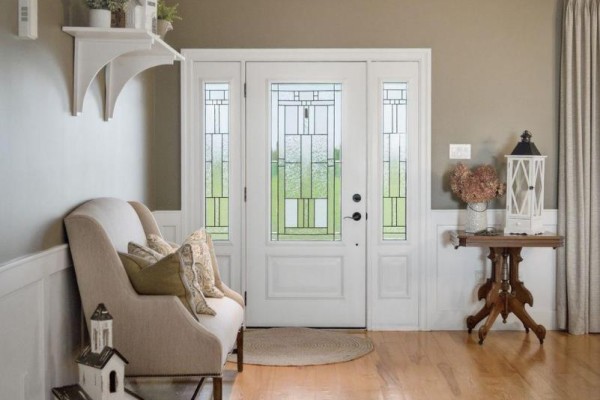 Home entryway with a white double door, leaded glass sidelights, and light beige seating. - 431 Meadowview Road, Kawartha Lakes