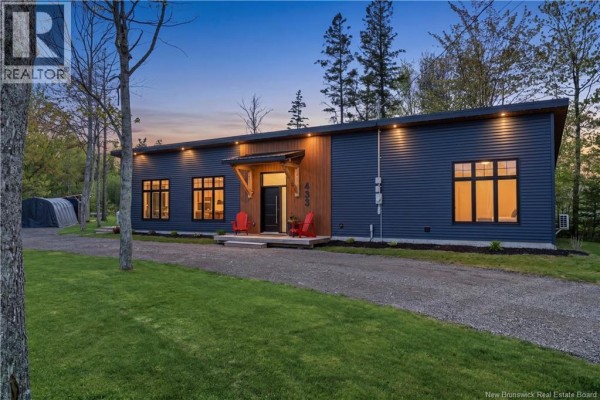 Backyard features a small pond, a wooden bench, and a greenhouse surrounded by trees. - 433 Cornwall Road, Shediac