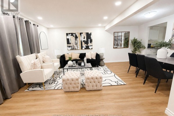 Living and dining area with wood floors and neutral decor. - 433a Dunvegan Drive, Waterloo