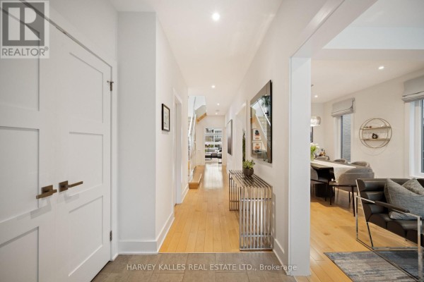 Bathroom with a double vanity, white quartz countertops, a toilet, and a large mirror. - 434 Bedford Park Avenue, Toronto