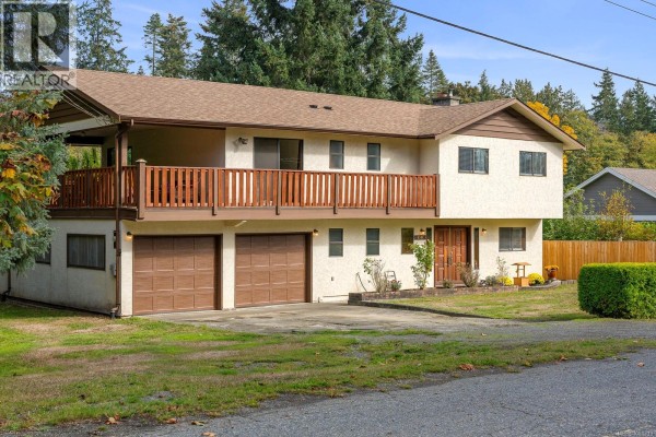 Front exterior of a split-level house with a covered balcony and double garage. - 4344 Briardale Rd, Royston