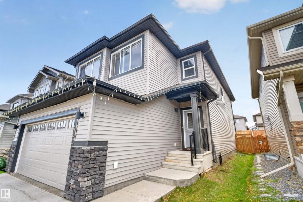 Entryway with gray walls, wood flooring, and open layout to the kitchen - 435 41 Av Nw, Edmonton