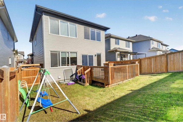 Staircase with carpeted steps, leading to upper level, and open living area - 435 41 Av Nw, Edmonton