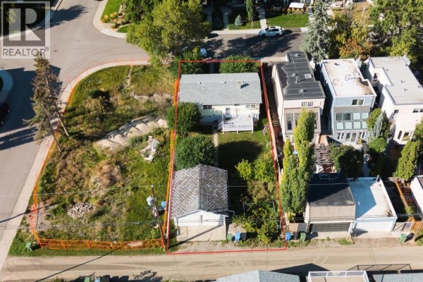 Aerial view showing a house, garage, and vacant lot with a red outline. - 435 51 Avenue, Calgary