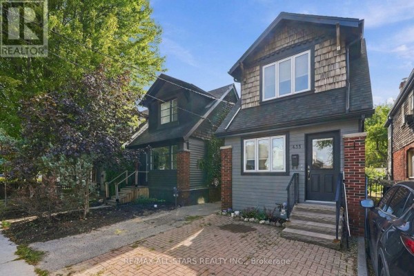 Aerial view of a residential street showing multiple houses with driveways and yards. - 435 Mortimer Avenue, Toronto