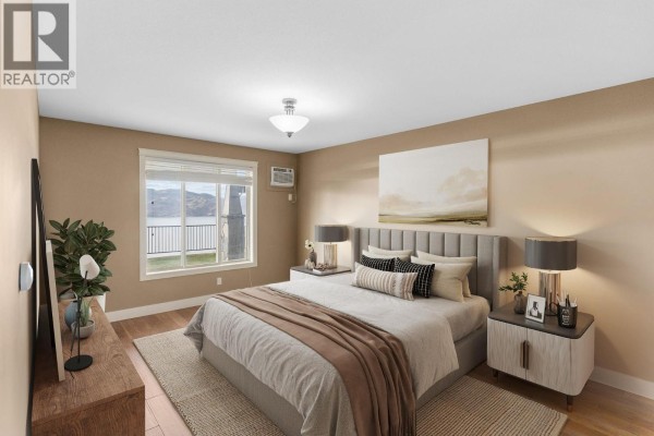 Bedroom with a queen-size bed, dresser, and a large window overlooking the lake. - 4350 Ponderosa Drive Unit# 108, Peachland