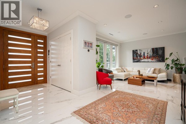 Interior view of the foyer and living room with white marble floors and large windows. - 4365 Mountain Highway, North Vancouver