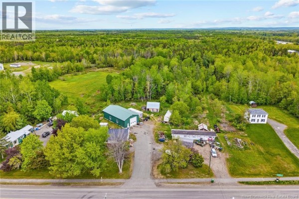 Aerial view of a property with a house, garage, and outbuildings surrounded by trees. - 4367 Heritage Drive, Tracy