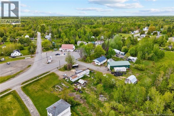 Aerial view of a small rural community with various buildings and a road intersection. - 4367 Heritage Drive, Tracy