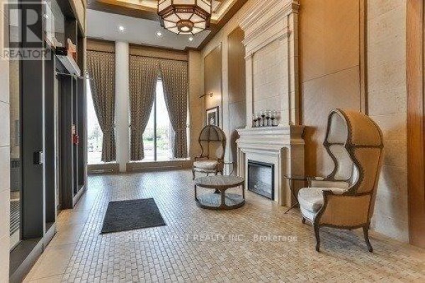 Building lobby with a fireplace, seating area, and patterned tile floor. - 437 - 36 Via Bagnato, Toronto