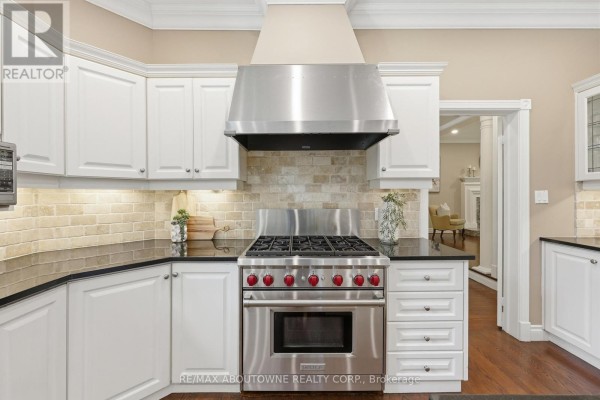 Wolf range and white cabinets in kitchen - 437 Cairncroft Road Oakville
