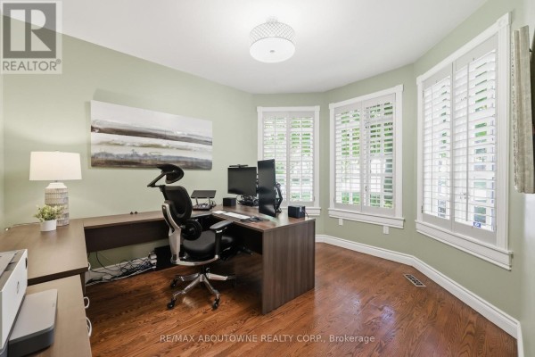 Office with L-shaped desk, ergonomic chair, dual monitors, and plantation shutters - 437 Cairncroft Road Oakville