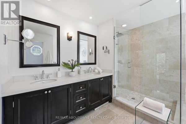 Modern double vanity and glass walk-in shower with stone tiles - 437 Cairncroft Road Oakville