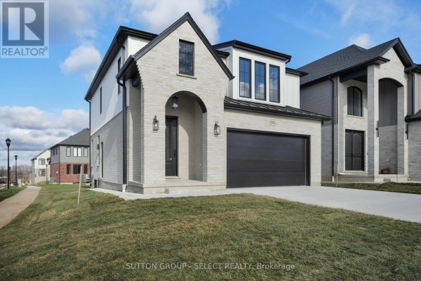 Contemporary kitchen with light grey cabinets, white countertops, and stainless steel appliances. - 4387 Green Bend Road, London South