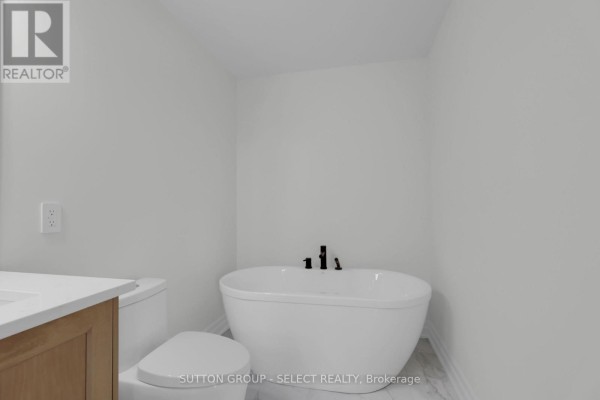 Freestanding tub and vanity in a modern bathroom - 4387 Green Bend Road London South