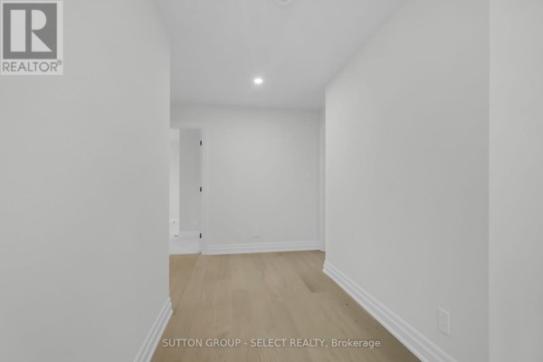Hallway with hardwood floors and white baseboards - 4387 Green Bend Road London South