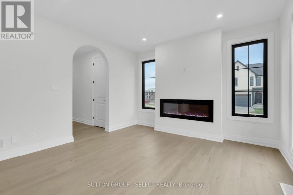 Living room with electric fireplace and large windows - 4387 Green Bend Road London South