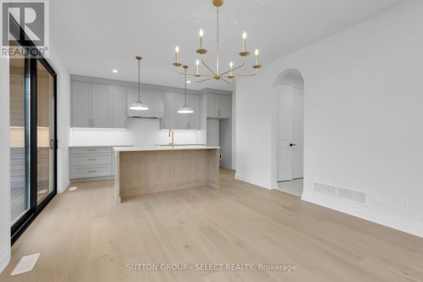 Modern kitchen with island and gold chandelier - 4387 Green Bend Road London South