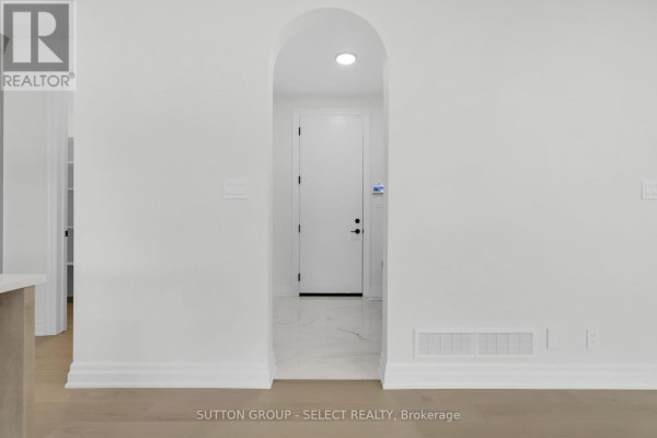 Arched doorway with white door, marble and wood floors - 4387 Green Bend Road London South