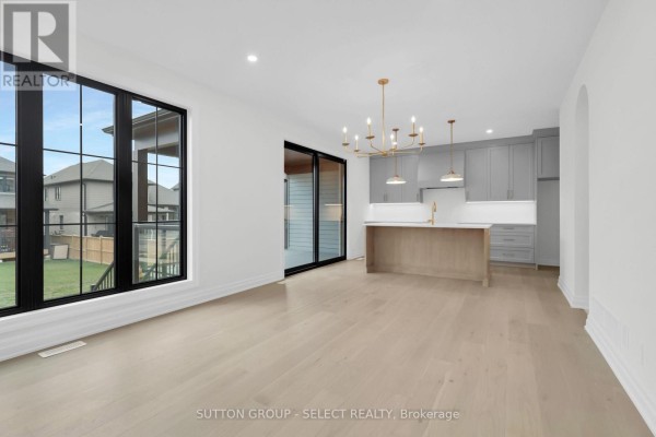 Modern kitchen with island and gray cabinets, large window, sliding door - 4387 Green Bend Road London South