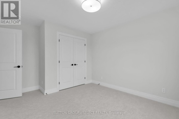 Bedroom with white closet doors and neutral carpet - 4387 Green Bend Road London South