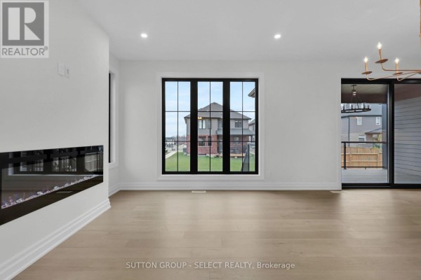 Living room with electric fireplace and large window - 4387 Green Bend Road London South