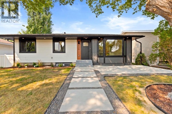 Close-up front exterior view showing the house number nine on wood panelling. - 439 Arlington Drive Se, Calgary