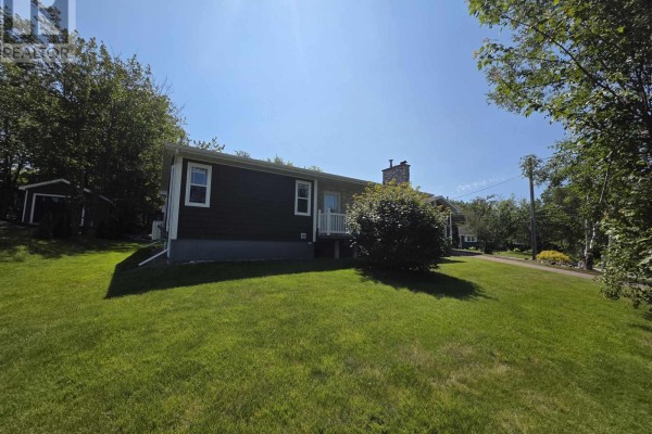 Side view of the house with gravel driveway and lawn. - 44 Beaumont Avenue, Sydney River
