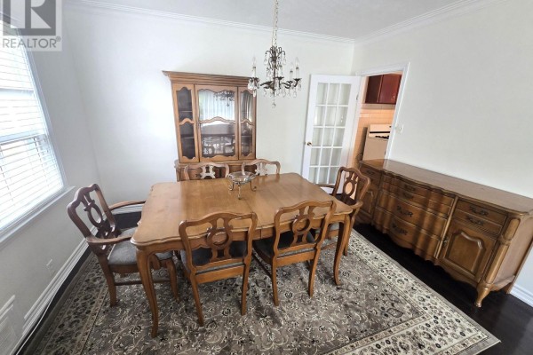 Dining room with wooden table and chairs, china cabinet, sideboard, and chandelier. - 44 Janet Boulevard, Toronto