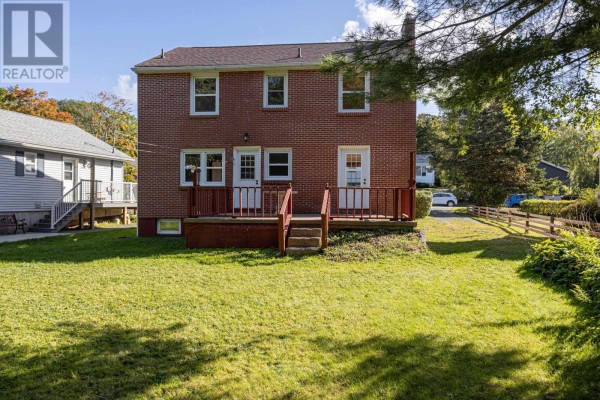 Backyard of the house with a wooden deck, stairs, and a wooden fence. - 44 Locks Road, Dartmouth
