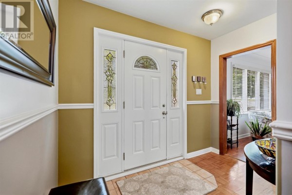 Interior view of the home's entryway with a white door and stained glass accents. - 44 Mccrea St, Sault Ste  Marie