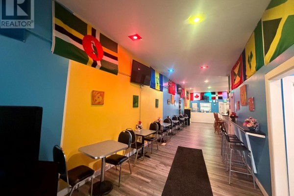Interior dining area with colorful walls adorned with national flags. - 44 Robinson Street, Norfolk