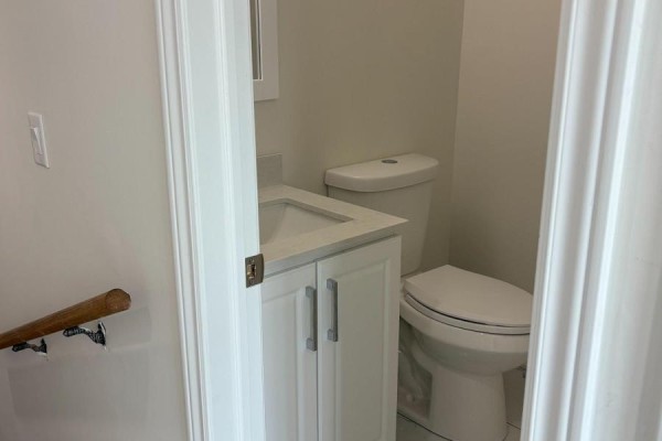 Small bathroom with a white toilet, vanity, and sink with a gray countertop. - 44 Sylvia Street, Barrie