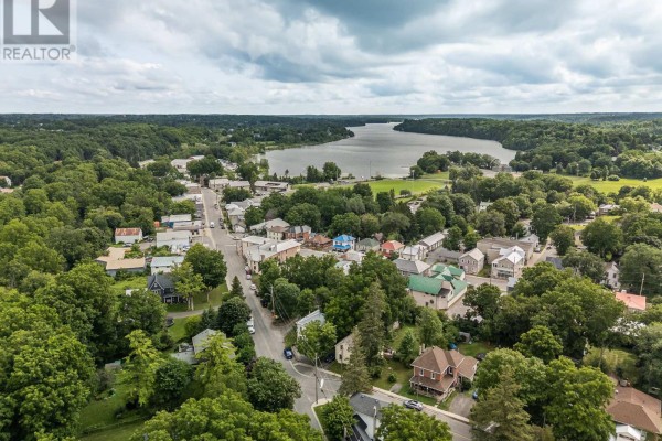 Aerial view of a residential area with houses, trees, and a body of water. - 4400 William Street, Frontenac