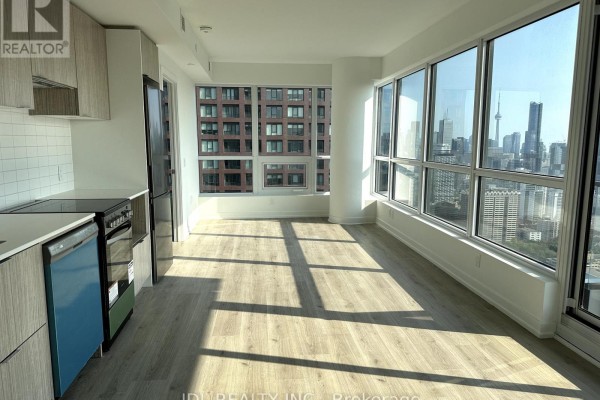 Kitchenette with stainless steel appliances, white tiled backsplash, and wood-look cabinetry. - 4402 - 395 Bloor Street E, Toronto