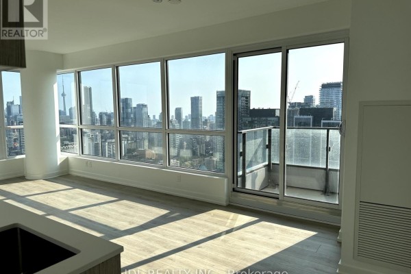 Living area featuring floor-to-ceiling windows, a sliding glass door to a balcony, and city views. - 4402 - 395 Bloor Street E, Toronto