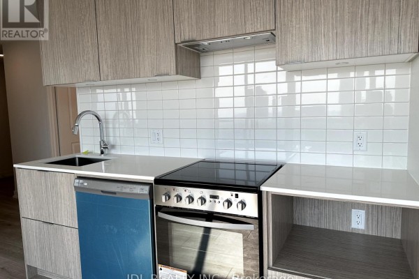 Kitchen counter with sink, faucet, dishwasher, stove, and white subway tile backsplash. - 4402 - 395 Bloor Street E, Toronto