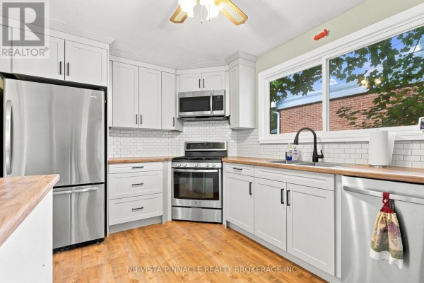 Modern kitchen with stainless steel appliances, subway tile, and wood accents - 442 Grandview Avenue Wilmot