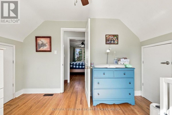 Bedroom with blue dresser, changing table, and moose artwork - 442 Grandview Avenue Wilmot
