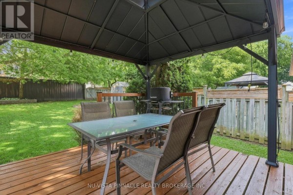 Covered deck with dining set and grill - 442 Grandview Avenue Wilmot