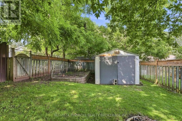 Fenced backyard with shed, garden bed, and fire pit - 442 Grandview Avenue Wilmot