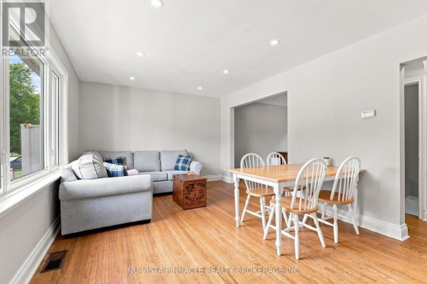 Living and dining area with sectional sofa, dining set, and hardwood floors - 442 Grandview Avenue Wilmot