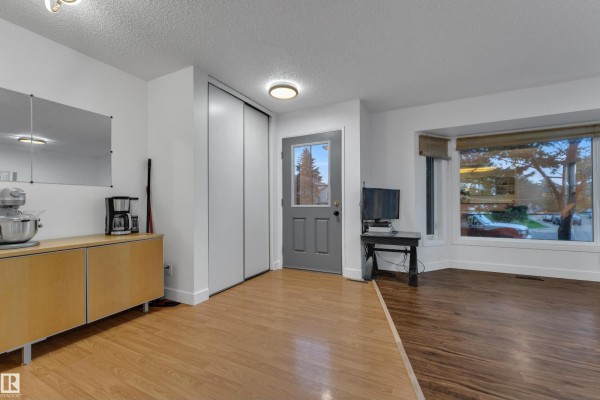 Side view of a house with trees and landscaping in the yard. - 442 Kirkpatrick Cr Nw, Edmonton