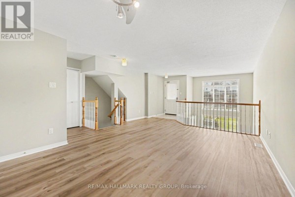 Kitchen with white appliances, green walls, and laundry area with washer and dryer. - 4429 Harper Avenue, Ottawa