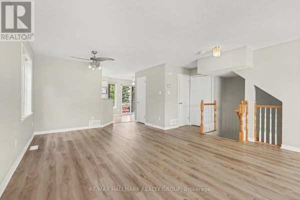 Dining area with wooden table and chairs, sliding glass door to balcony, and green walls. - 4429 Harper Avenue, Ottawa