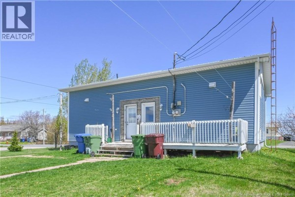 Back exterior of a blue vinyl-sided building with two separate entrances and white railings. - 443 Chemin Haut-shippagan Road, Haut Shippagan