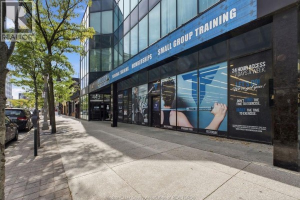View of the gym storefront from the sidewalk, showing the entrance and windows. - 443 Ouellette Avenue, Windsor