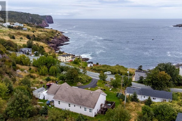 Aerial view of the property showcasing the house, surrounding terrain, and panoramic ocean vistas. - 443 Wind Gap Road, Flatrock